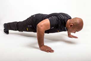 A bald man doing pushup