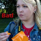 A white woman taking snacks